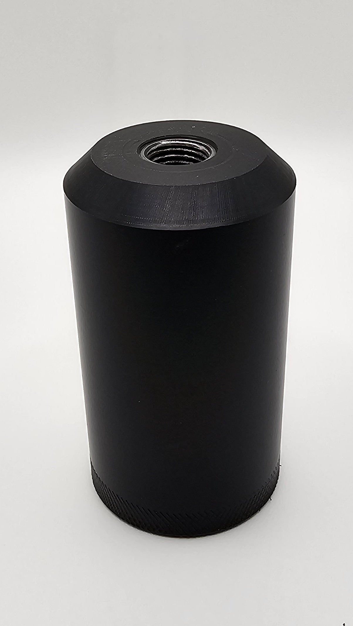 Black cylindrical container on a white background, shift knob, black, white, delrin, weighted, clean, tapered
